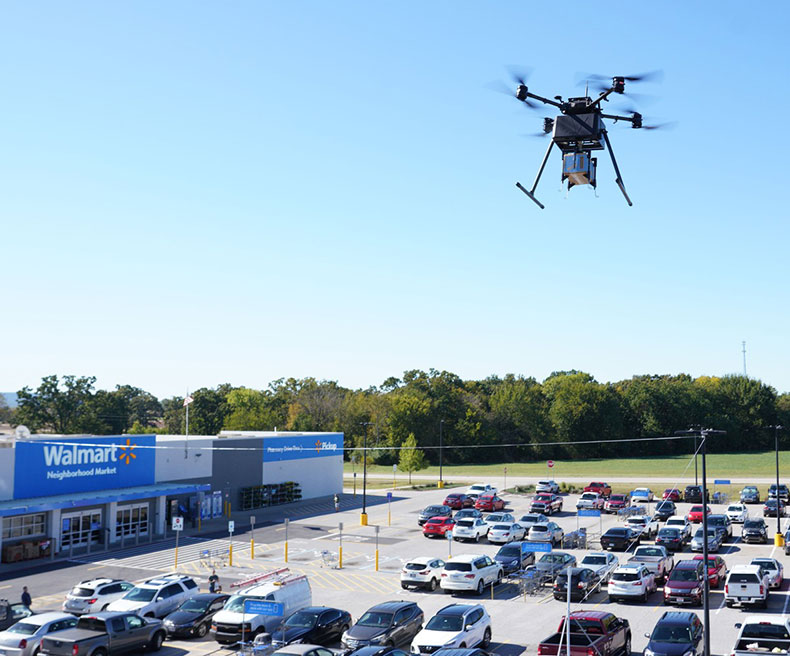 A drone delivers a package from a Walmart Supercenter.